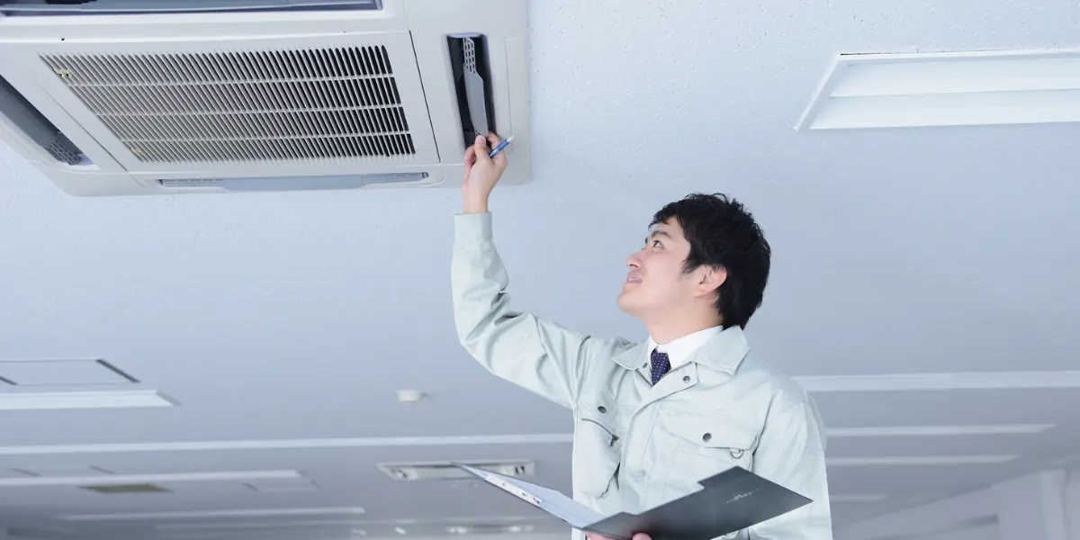 HVAC student checking refrigerant pressures in a training lab