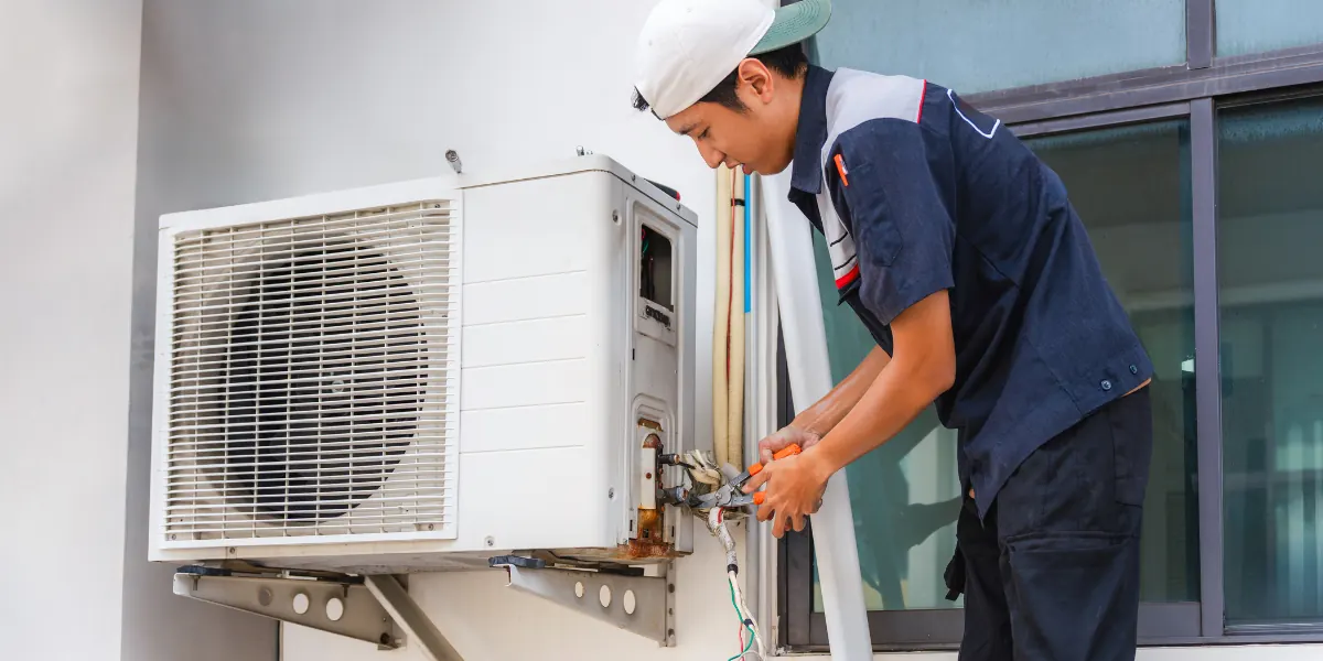 HVAC student servicing an air conditioning unit