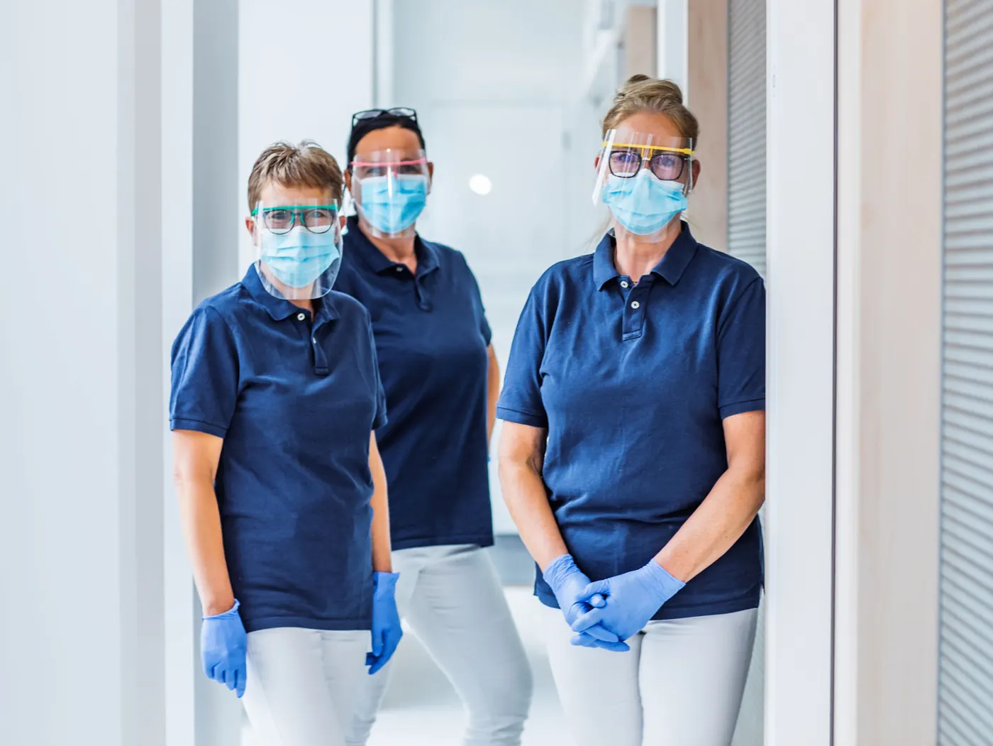 Healthcare professionals in scrubs caring for patients