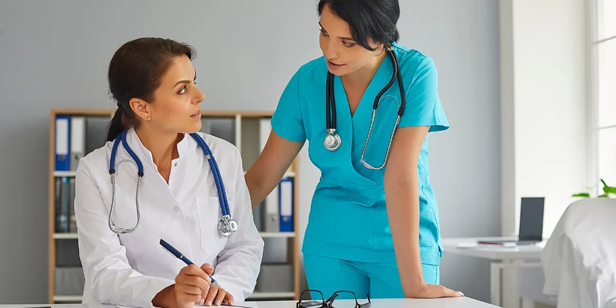 Nursing assistant and medical assistant working with a patient