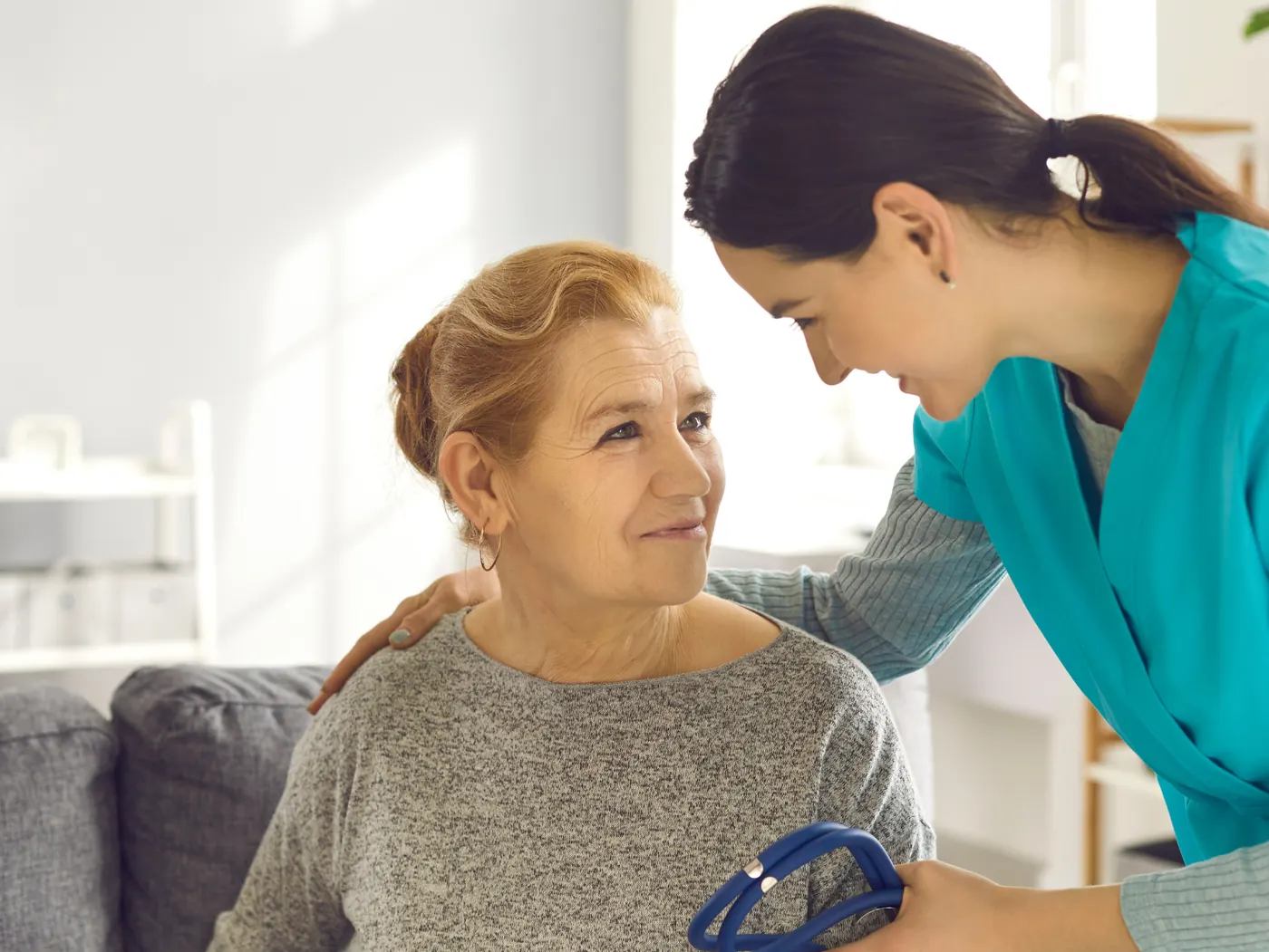 Home health aide student helping a patient with daily living tasks