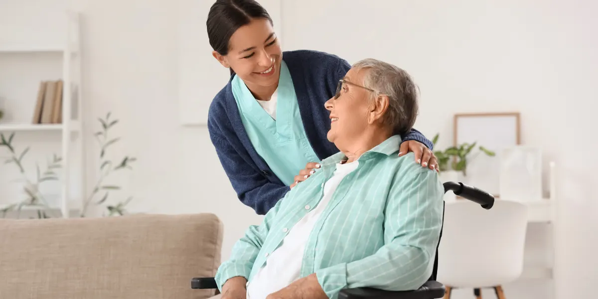 Home health aide helping an older adult at home
