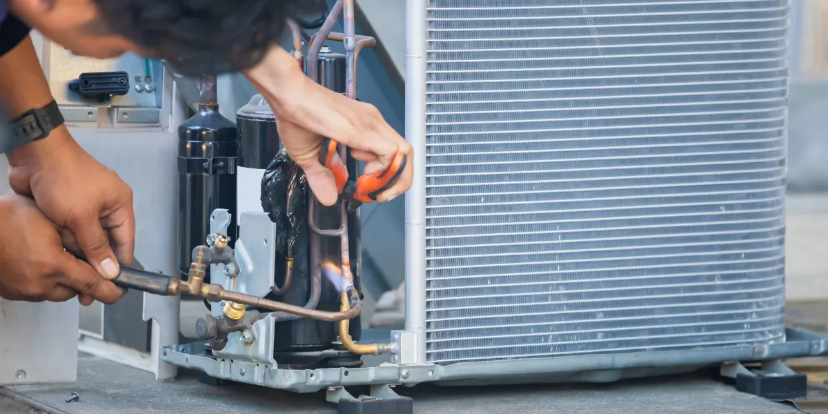 HVAC technician servicing an air conditioning unit