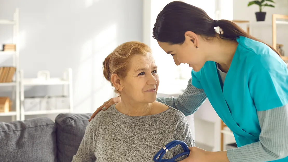 Home health aide providing compassionate care to an elderly patient